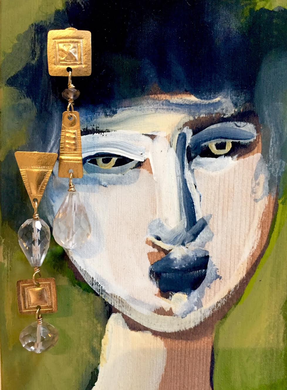 Hand-fabricated gold with quartz earrings displayed on a painting by Susan Brooks.  Photo: Susan Brooks